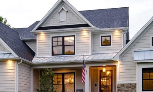 Light gray James Hardie siding with board-and-batten accents and stone detailing on a Connecticut home.”