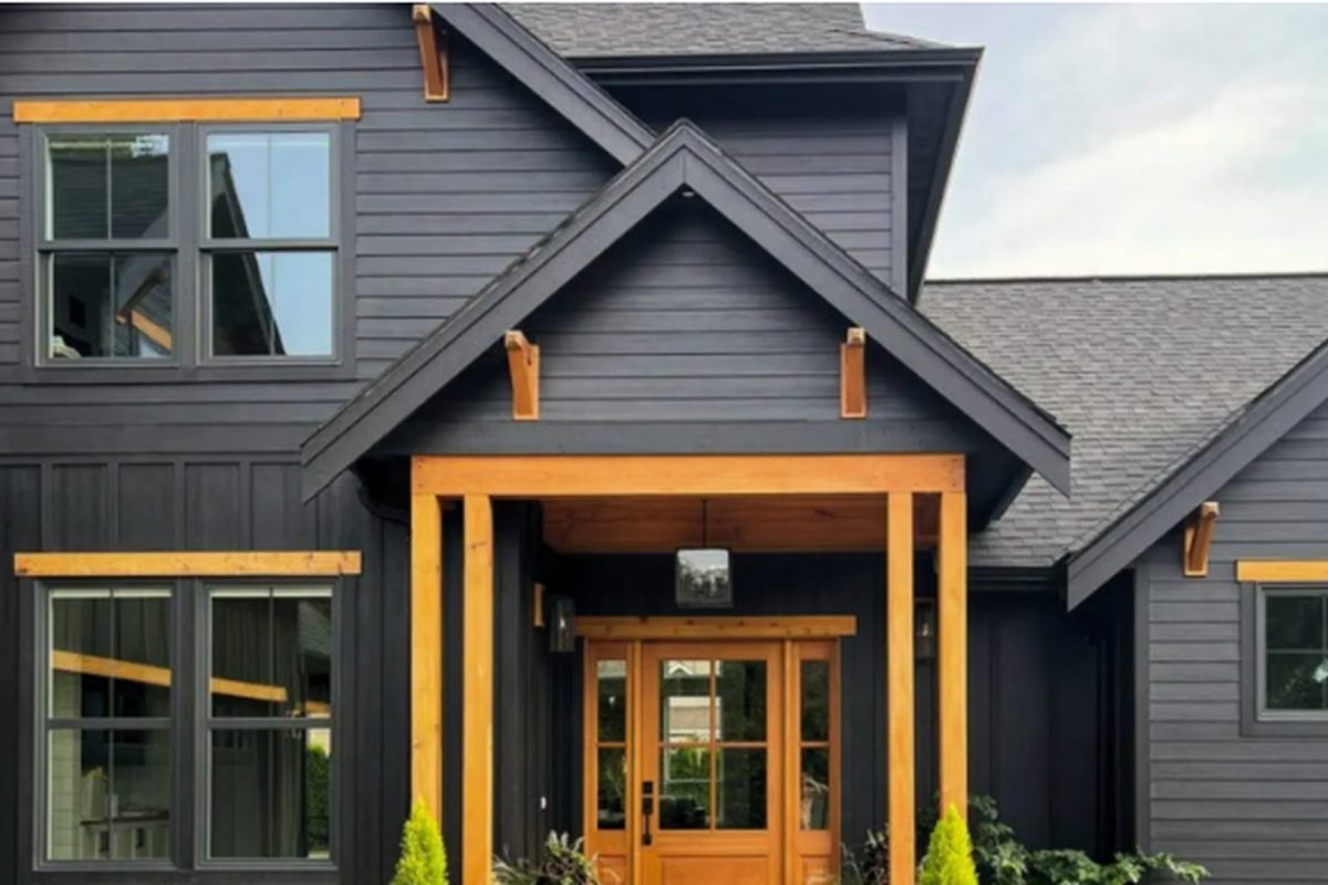 Modern dark gray siding home with natural wood trim installed by MJT Siding in Connecticut.